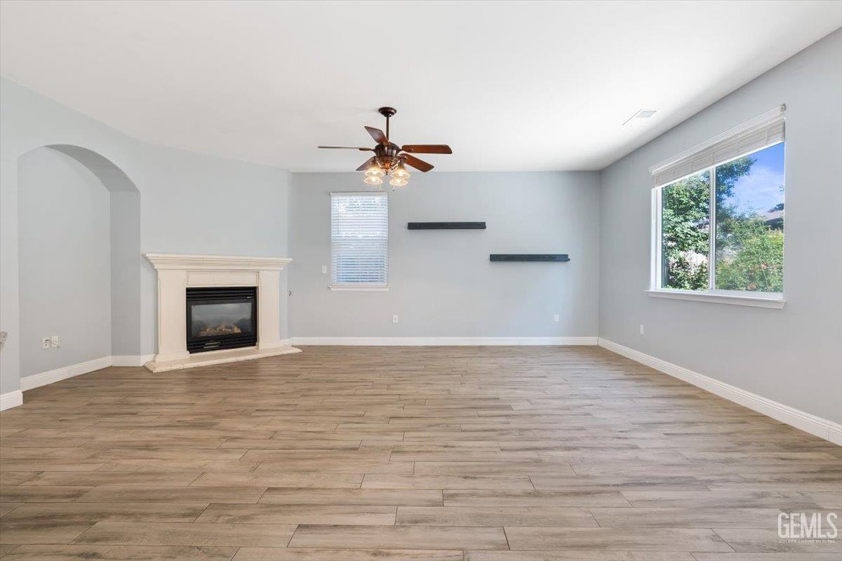 Undisclosed Address Bakersfield, CA 93312 - Photo 31 of 45 a view of empty room with wooden floor and fireplace