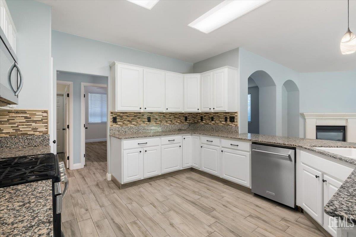 Undisclosed Address Bakersfield, CA 93312 - Photo 36 of 45 a kitchen with granite countertop white cabinets and white appliances