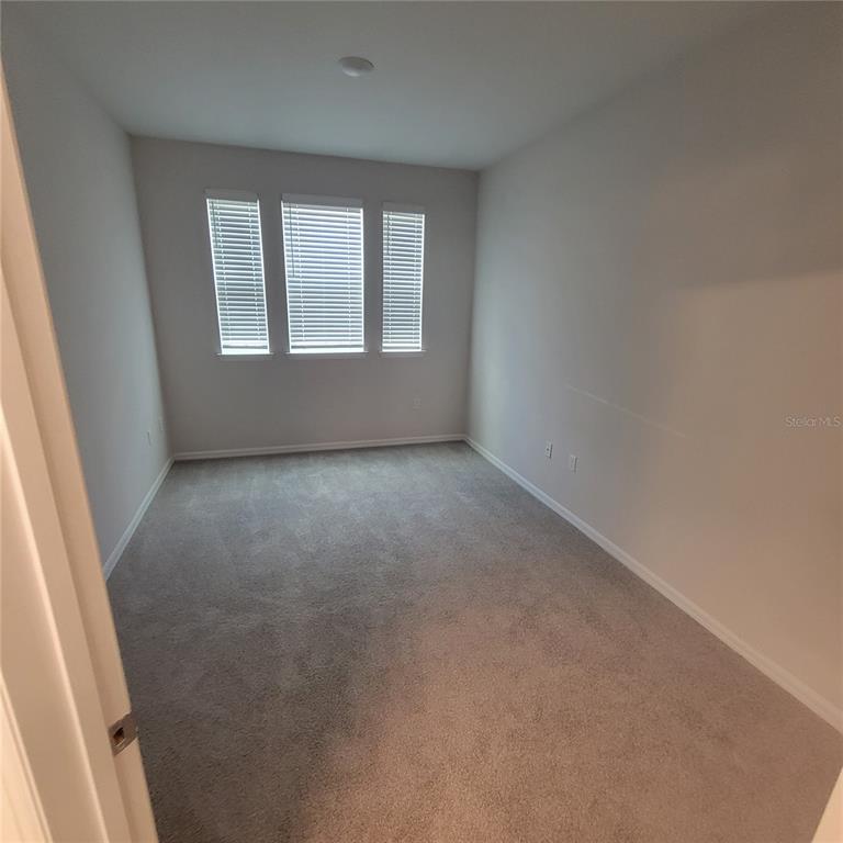 6407 Brook Village Cove, Unit 102 Bradenton, FL 34202 - Photo 12 of 19 an empty room with windows