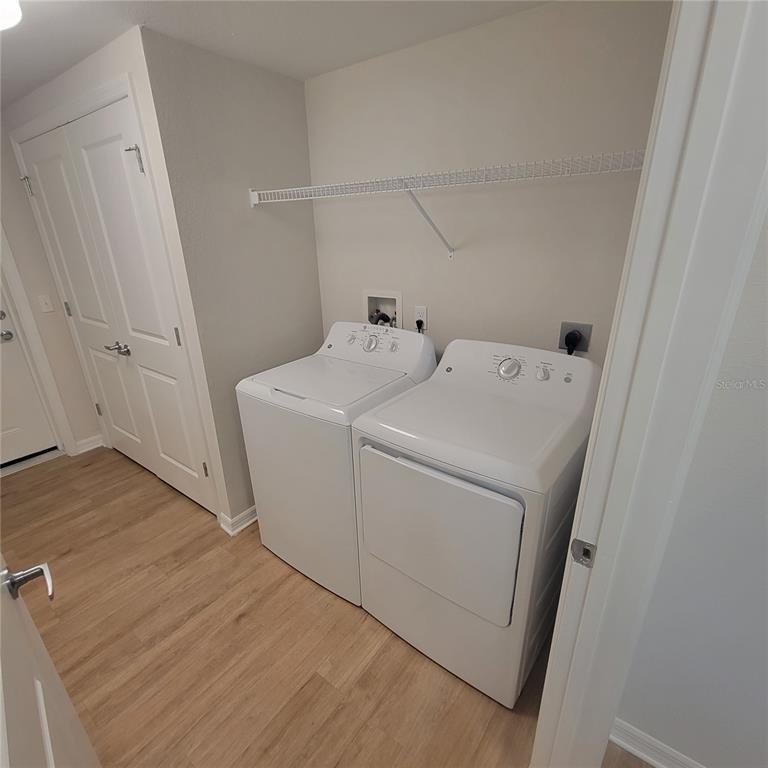 6407 Brook Village Cove, Unit 102 Bradenton, FL 34202 - Photo 19 of 19 a utility room with dryer and washer