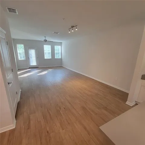 an empty room with windows and closet
