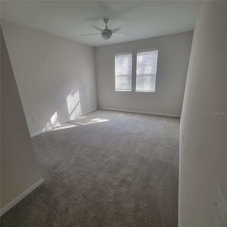 6407 Brook Village Cove, Unit 102 Bradenton, FL 34202 - Photo 7 of 19 an empty room with windows and closet