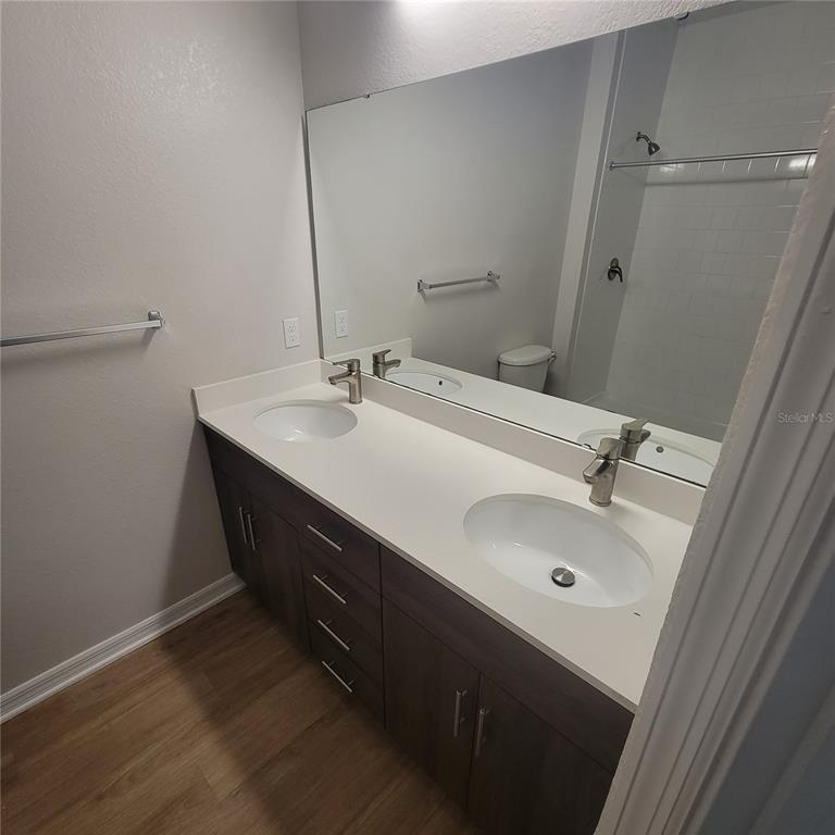 6407 Brook Village Cove, Unit 102 Bradenton, FL 34202 - Photo 8 of 19 a bathroom with a sink and a mirror