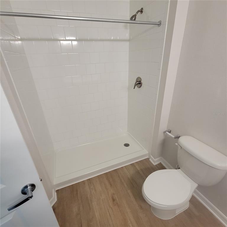 6407 Brook Village Cove, Unit 102 Bradenton, FL 34202 - Photo 9 of 19 a bathroom with a toilet and a shower