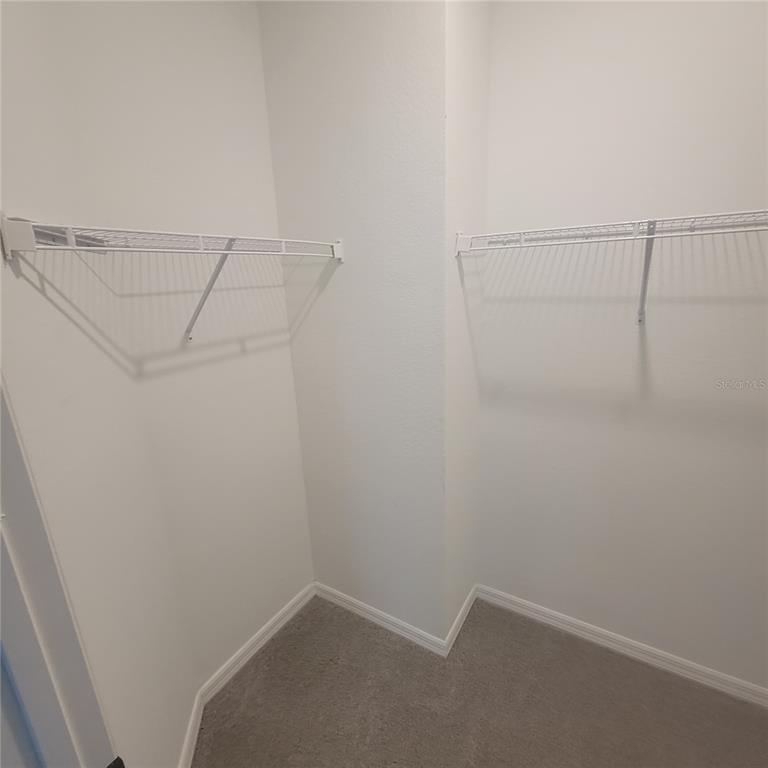 6407 Brook Village Cove, Unit 102 Bradenton, FL 34202 - Photo 10 of 19 a view of a room with racks on the wall