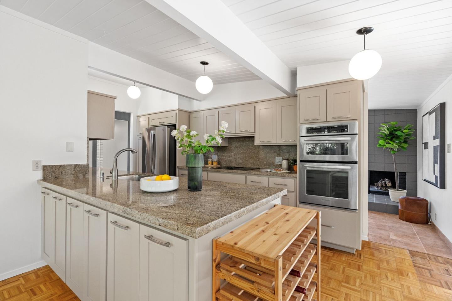 2018 Adele Place San Jose, CA 95125 - Photo 22 of 46 a kitchen with kitchen island granite countertop a stove cabinets and refrigerator
