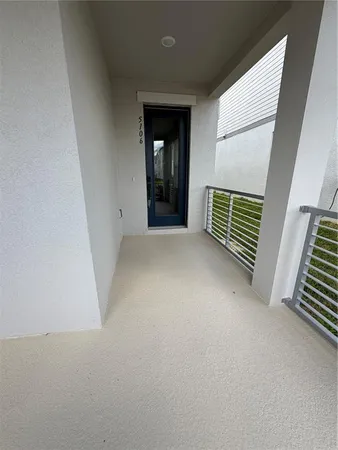 a view of a room with stairs and a floor to ceiling window