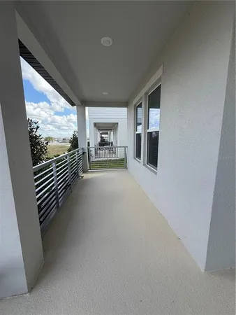 a hallway with a large window and sitting area