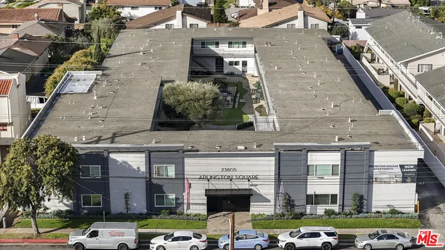 a front view of a building with parked cars