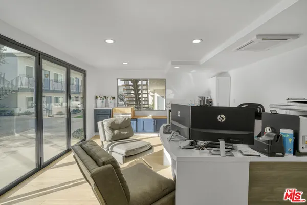 a living room with a couch and a floor to ceiling window
