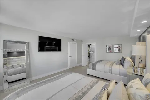a view of living room filled with furniture and large windows