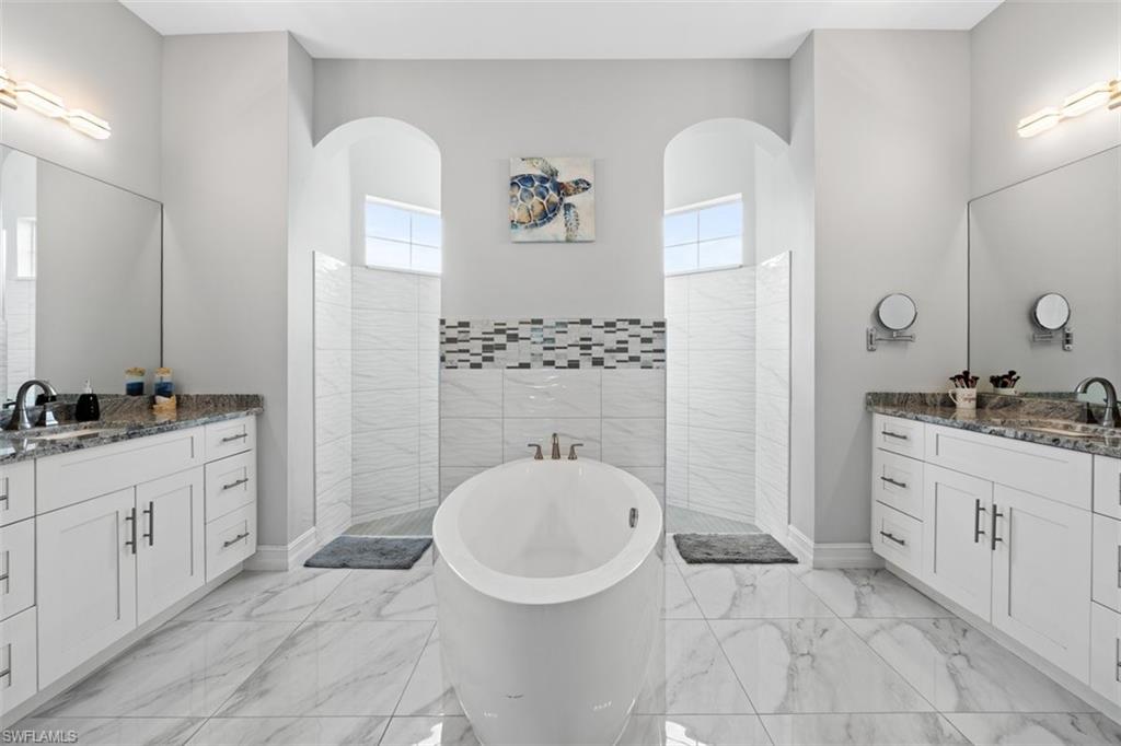 3611 8th Street Southwest Lehigh Acres, FL 33976 - Photo 11 of 21 a bathroom with a sink a toilet and a mirror