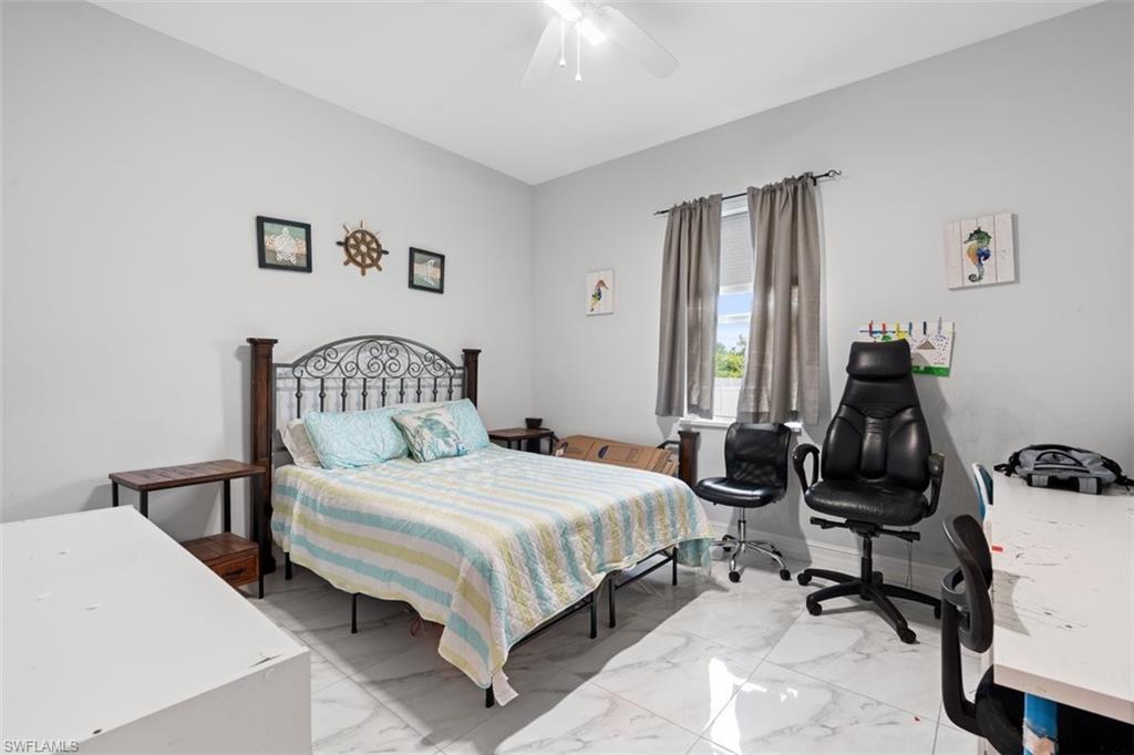3611 8th Street Southwest Lehigh Acres, FL 33976 - Photo 14 of 21 a bedroom with a bed and a window