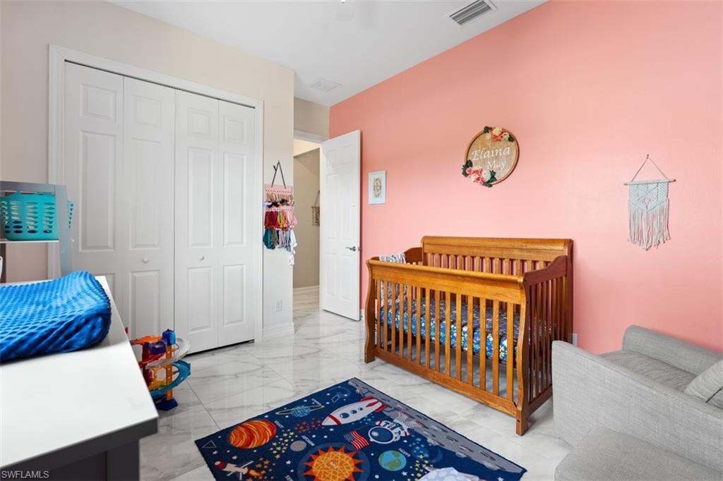 3611 8th Street Southwest Lehigh Acres, FL 33976 - Photo 16 of 21 a bedroom with furniture and a rug