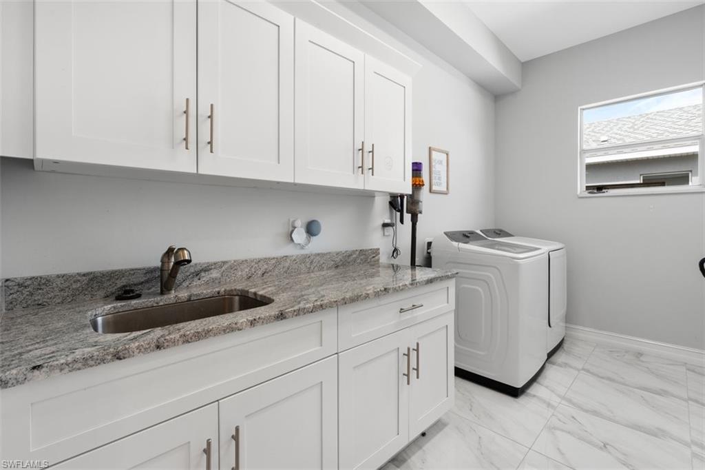 3611 8th Street Southwest Lehigh Acres, FL 33976 - Photo 18 of 21 a kitchen with white cabinets and sink