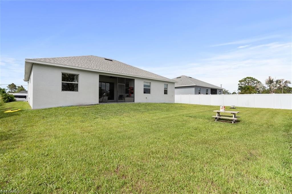 3611 8th Street Southwest Lehigh Acres, FL 33976 - Photo 20 of 21 a view of a house with a yard and sitting area