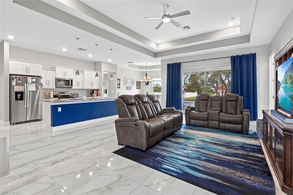 3611 8th Street Southwest Lehigh Acres, FL 33976 - Photo 3 of 21 a living room with kitchen island furniture and a kitchen view