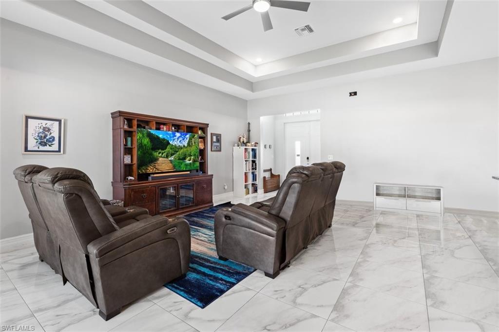 3611 8th Street Southwest Lehigh Acres, FL 33976 - Photo 4 of 21 a living room with furniture and a flat screen tv