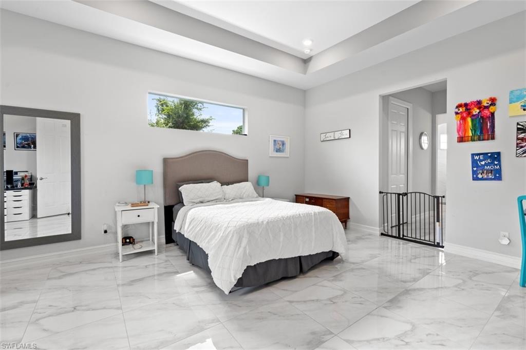 3611 8th Street Southwest Lehigh Acres, FL 33976 - Photo 8 of 21 a spacious bedroom with a bed and cabinets