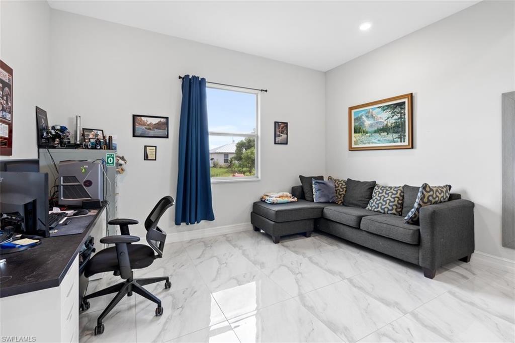 3611 8th Street Southwest Lehigh Acres, FL 33976 - Photo 10 of 21 a living room with furniture a couch and a flat screen tv