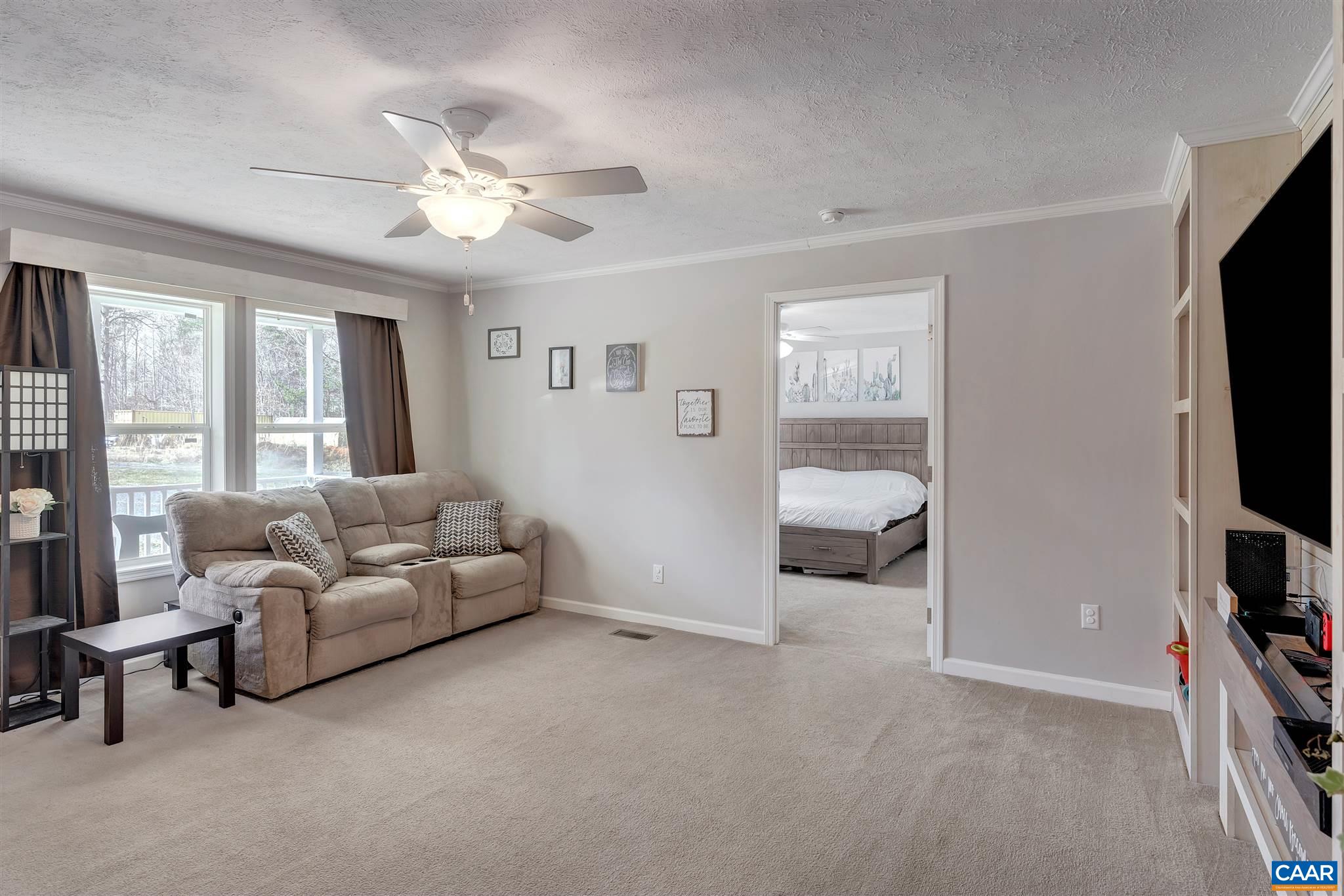 4491 Amicus Road Ruckersville, VA 22968 - Photo 13 of 37 a living room with furniture and a flat screen tv