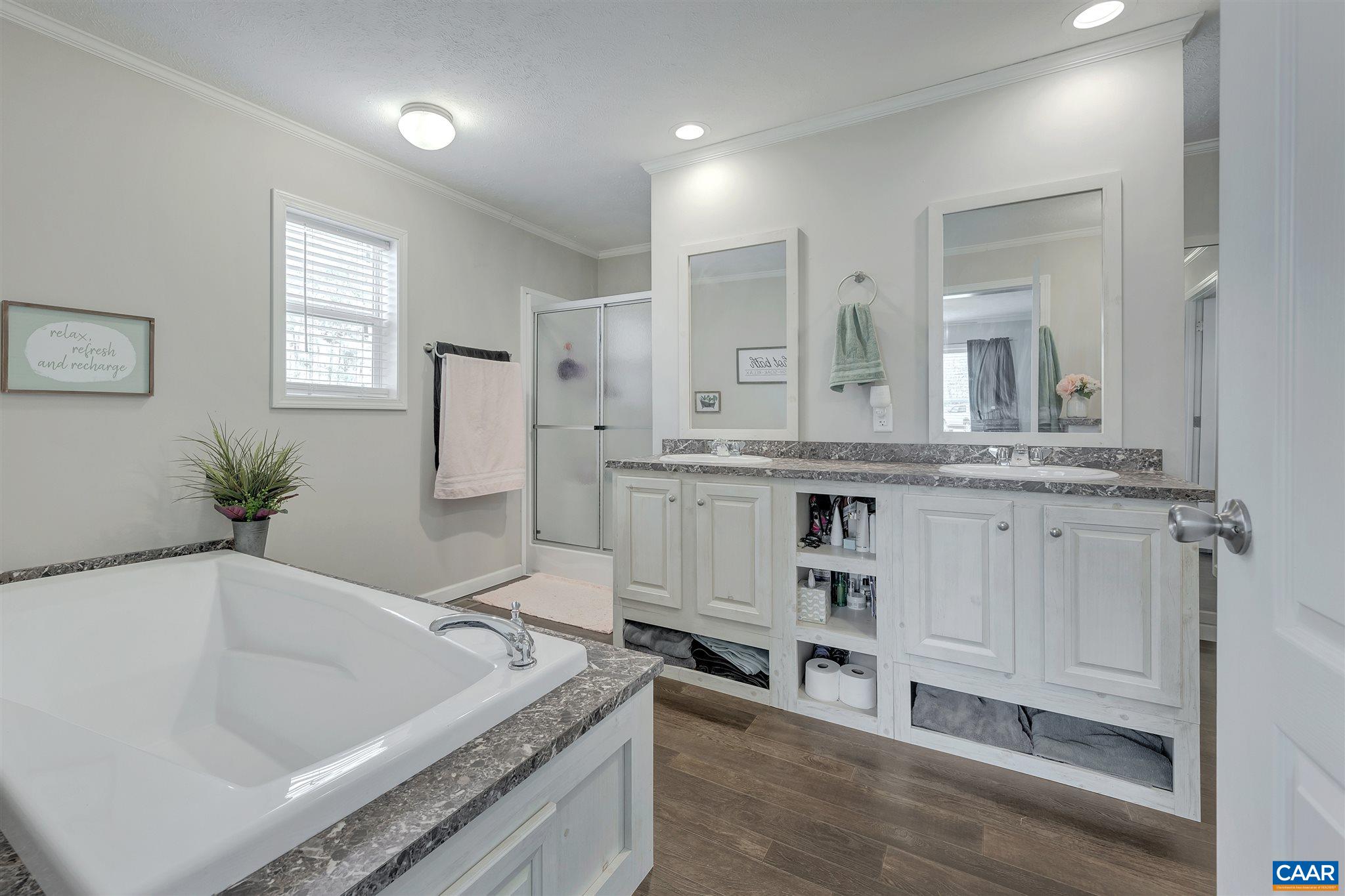 4491 Amicus Road Ruckersville, VA 22968 - Photo 16 of 37 a spacious bathroom with a granite countertop sink and a large mirror