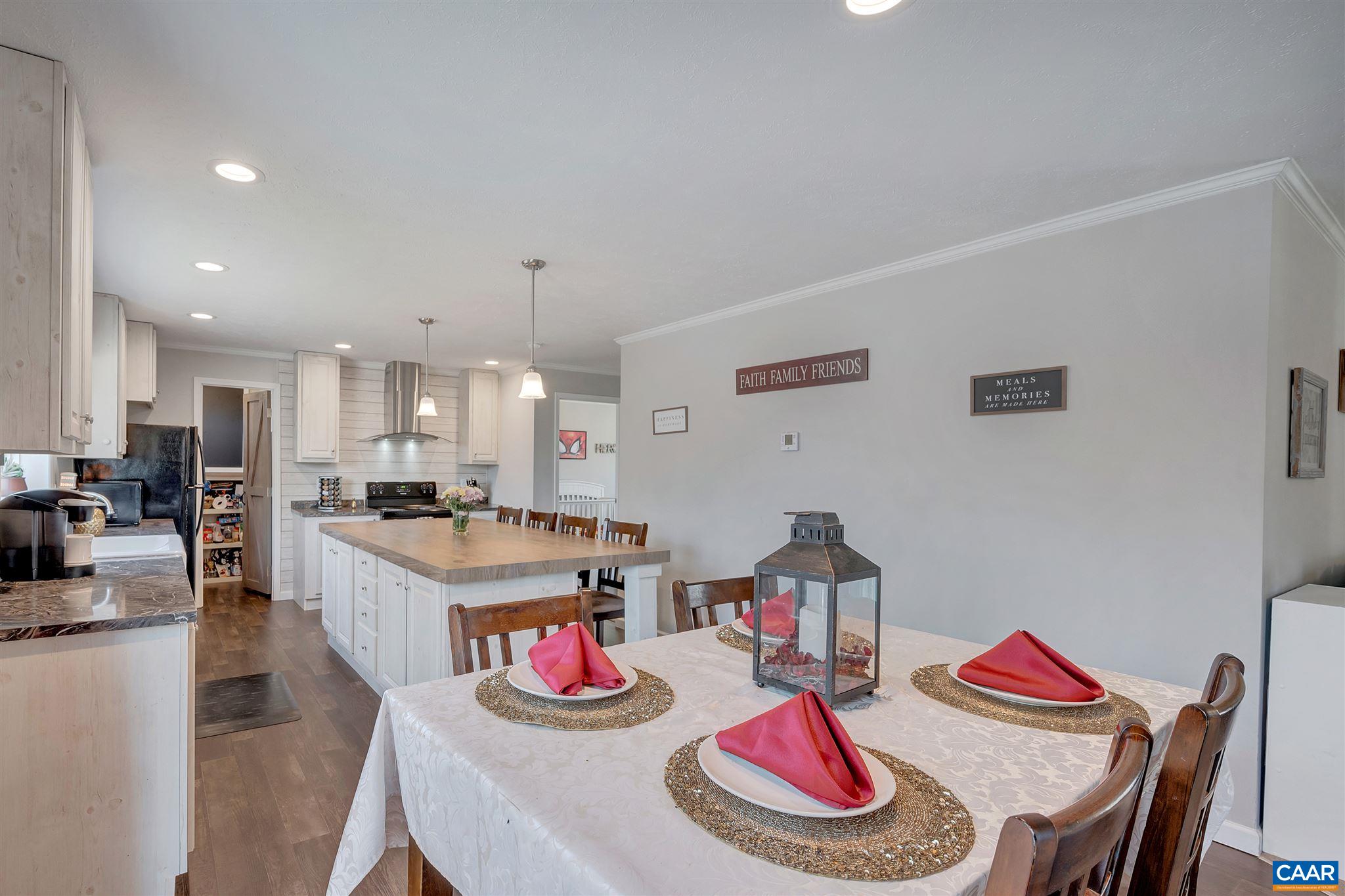 4491 Amicus Road Ruckersville, VA 22968 - Photo 21 of 37 a large kitchen with dining table and chairs