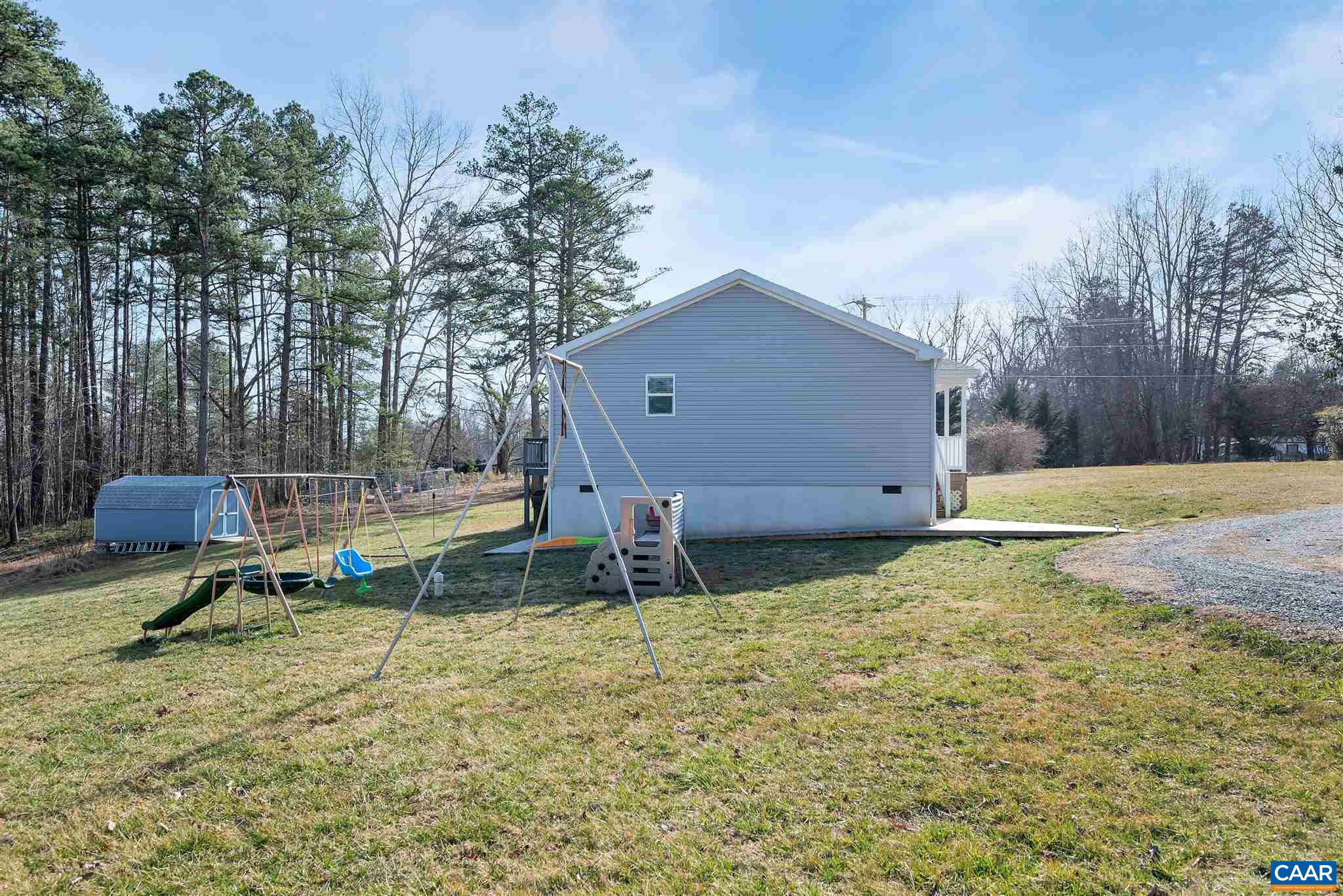 4491 Amicus Road Ruckersville, VA 22968 - Photo 29 of 37 a backyard of a house with table and chairs