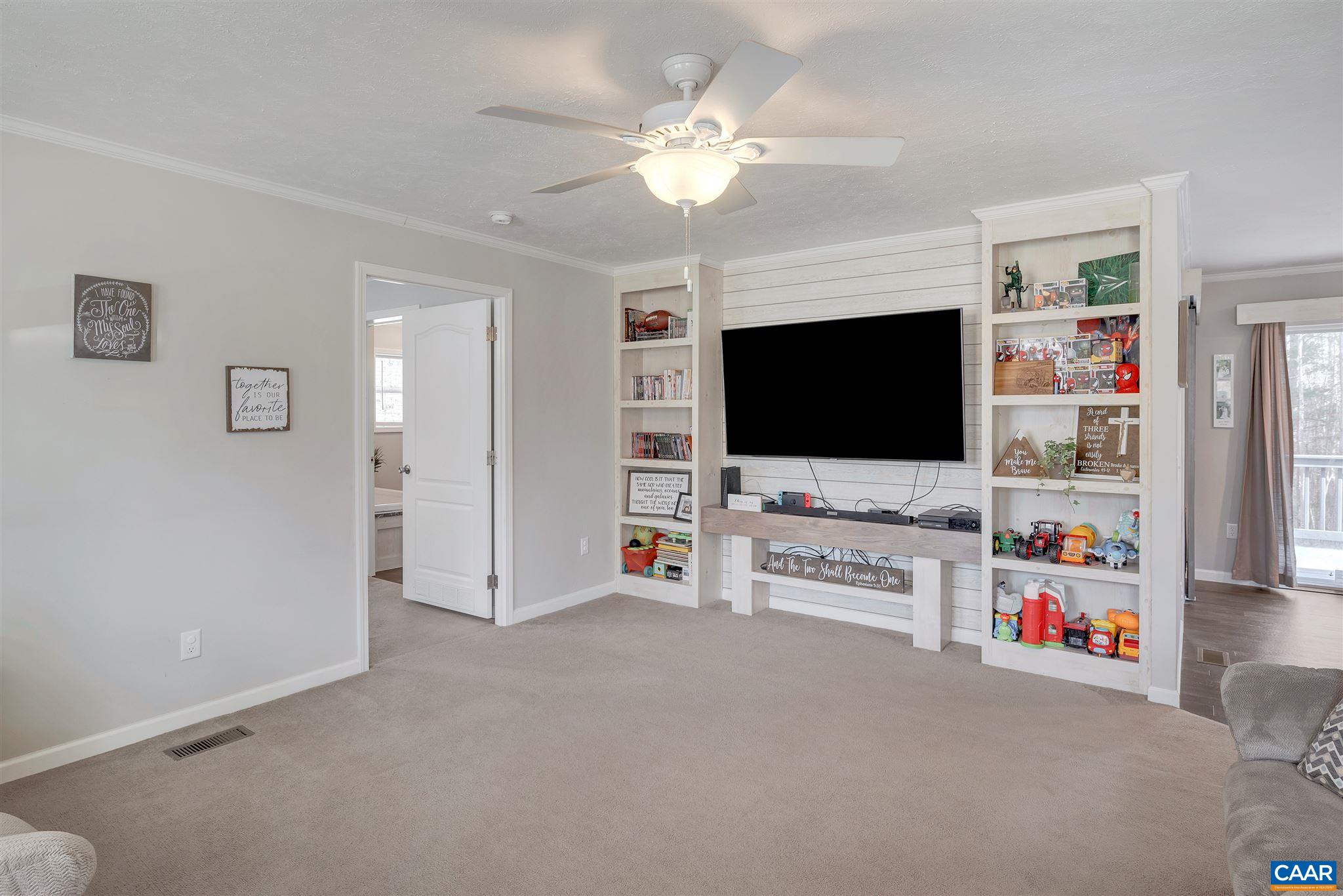 4491 Amicus Road Ruckersville, VA 22968 - Photo 3 of 37 a living room with furniture and a flat screen tv