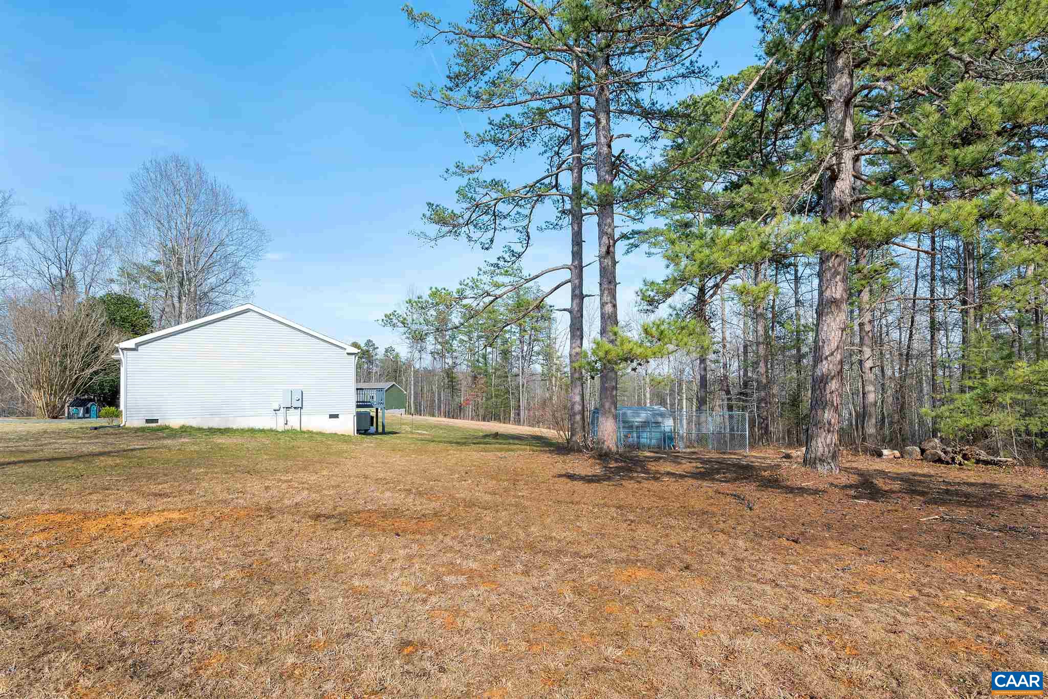 4491 Amicus Road Ruckersville, VA 22968 - Photo 31 of 37 a backyard of a house with large trees and outdoor seating