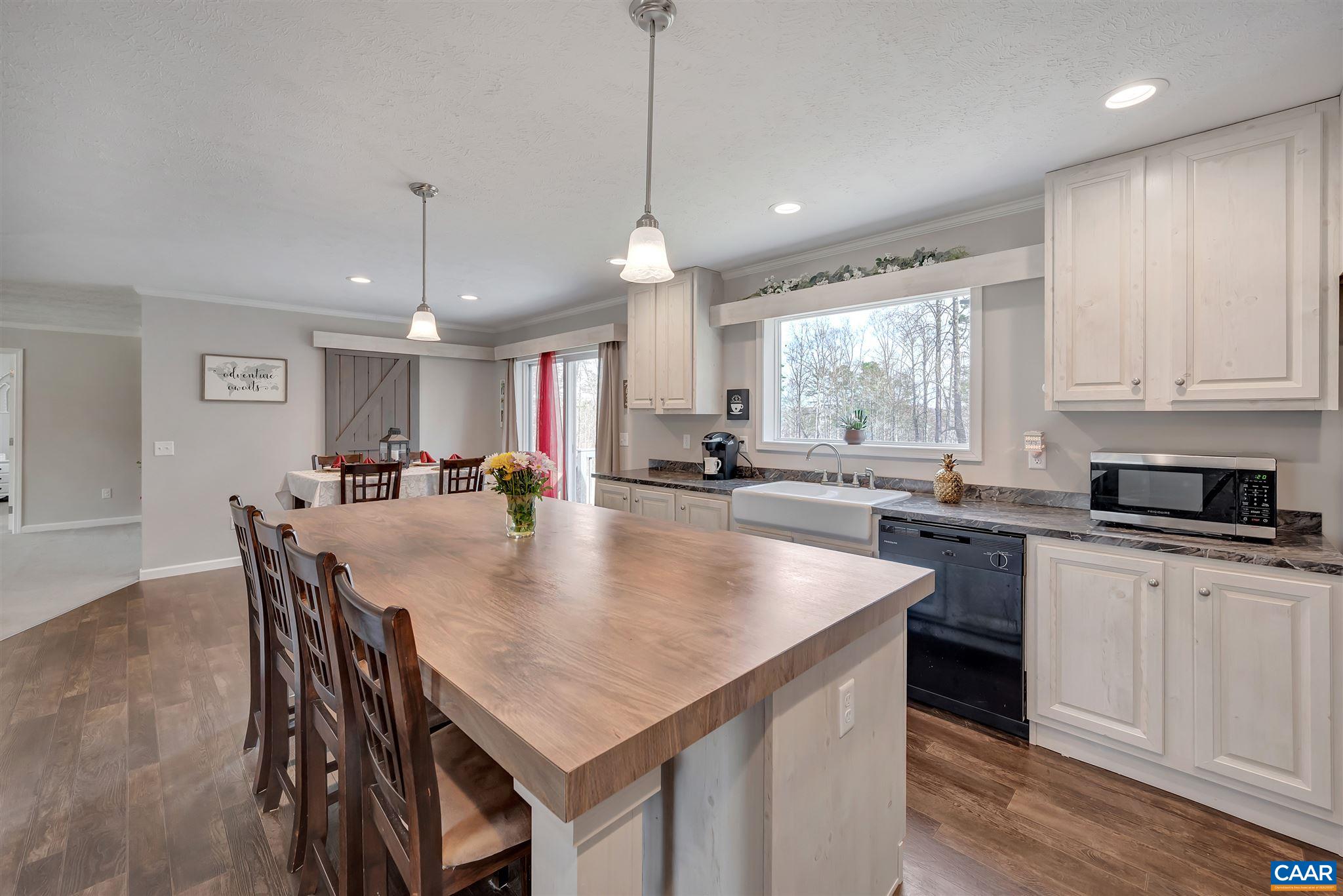 4491 Amicus Road Ruckersville, VA 22968 - Photo 6 of 37 a kitchen with center island table and chairs in it