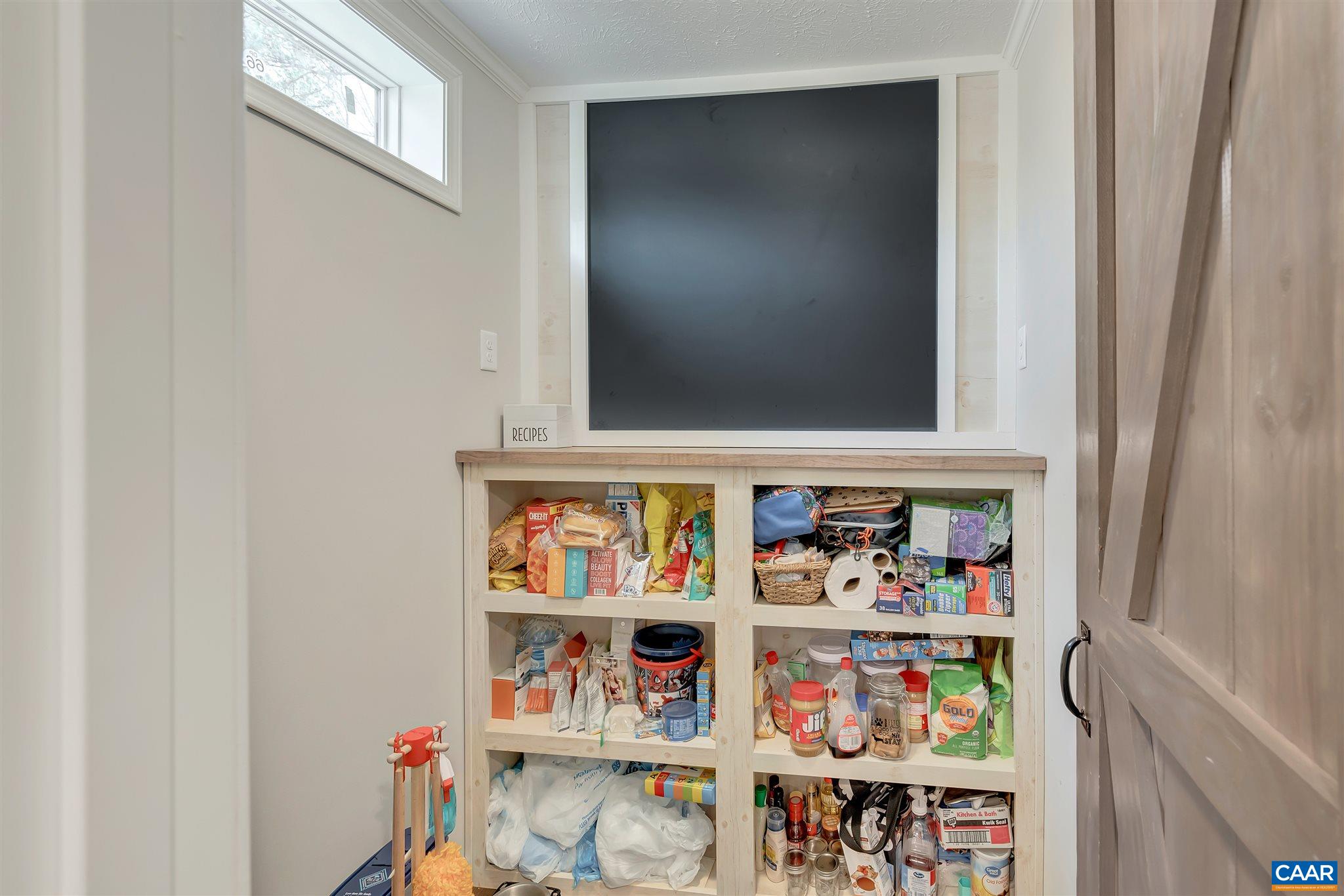 4491 Amicus Road Ruckersville, VA 22968 - Photo 8 of 37 a shelf with books and knick knacks on it