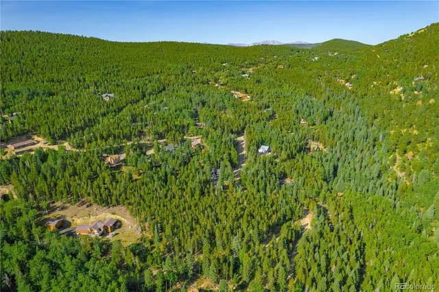 a view of a lush green hillside and mountains