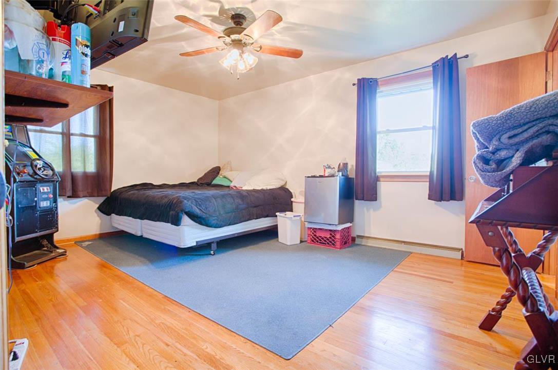 1239 Bushkill Center Road Nazareth, PA 18064 - Photo 5 of 14 a bedroom with a bed and a chandelier