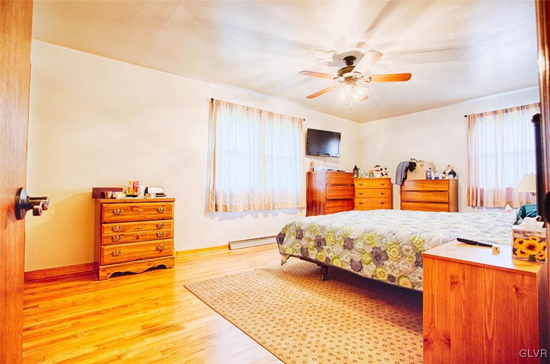 1239 Bushkill Center Road Nazareth, PA 18064 - Photo 6 of 14 a bedroom with a bed and a chandelier