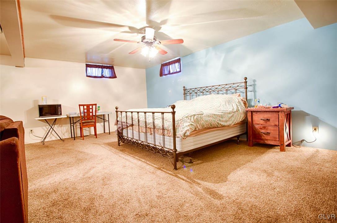 1239 Bushkill Center Road Nazareth, PA 18064 - Photo 10 of 14 a spacious bedroom with a bed and a table in it