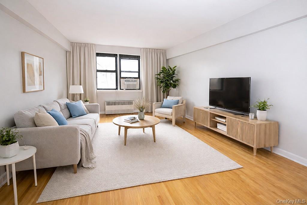 142 Garth Road, Unit 5S Scarsdale, NY 10583 - Photo 1 of 40 a living room with furniture and a flat screen tv