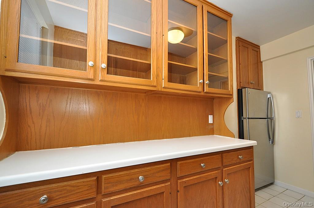 142 Garth Road, Unit 5S Scarsdale, NY 10583 - Photo 13 of 40 a view of a refrigerator cabinets