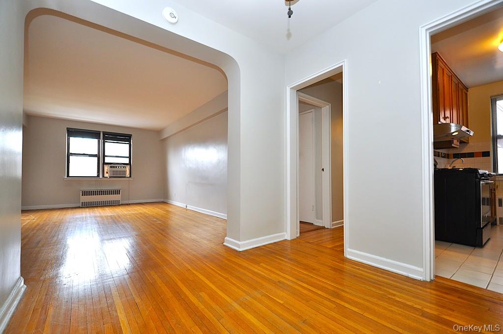 142 Garth Road, Unit 5S Scarsdale, NY 10583 - Photo 19 of 40 a view of empty room with wooden floor and fan