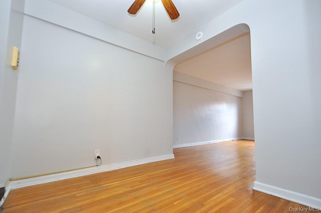 142 Garth Road, Unit 5S Scarsdale, NY 10583 - Photo 20 of 40 a view of an empty room with wooden floor