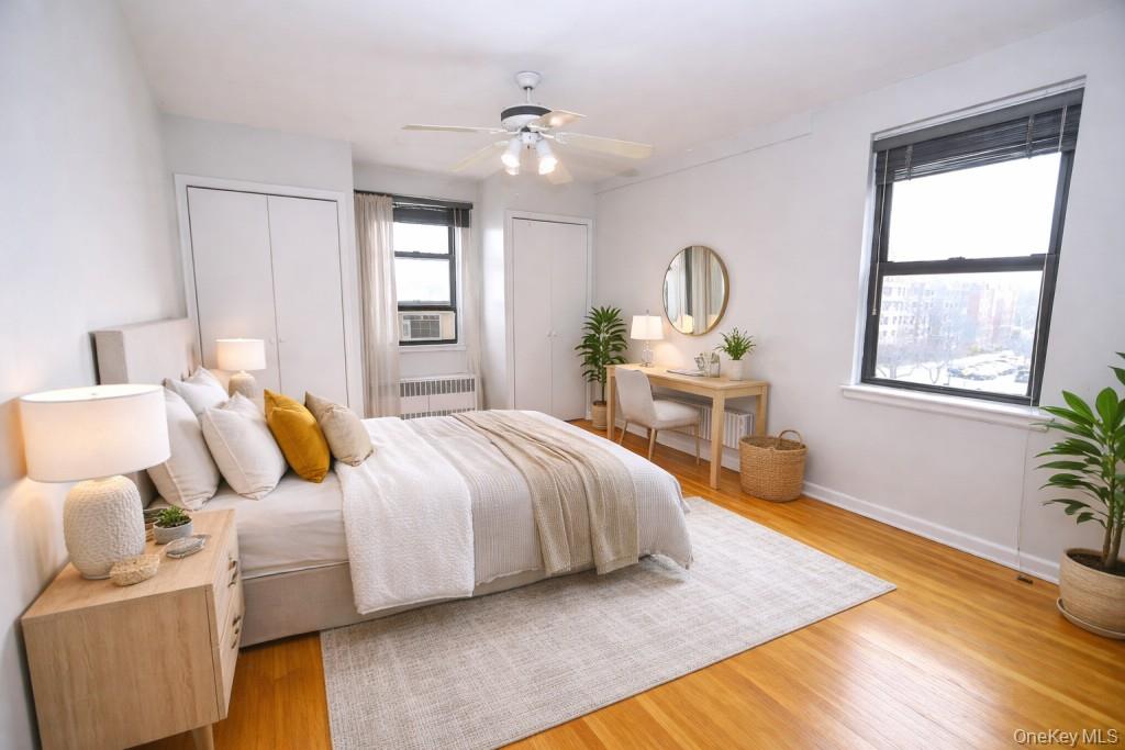 142 Garth Road, Unit 5S Scarsdale, NY 10583 - Photo 2 of 40 a bedroom with a bed and wooden floor
