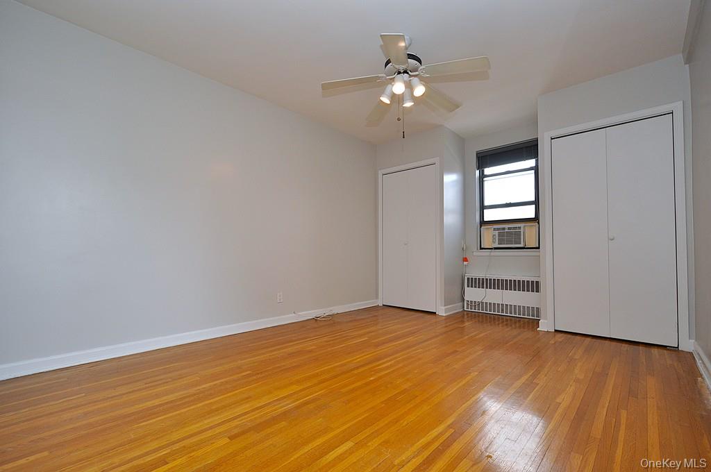 142 Garth Road, Unit 5S Scarsdale, NY 10583 - Photo 22 of 40 wooden floor in an empty room with a window