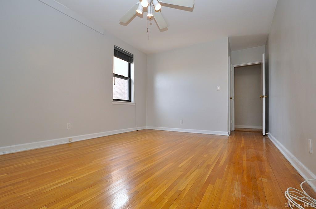 142 Garth Road, Unit 5S Scarsdale, NY 10583 - Photo 23 of 40 wooden floor in an empty room with a window