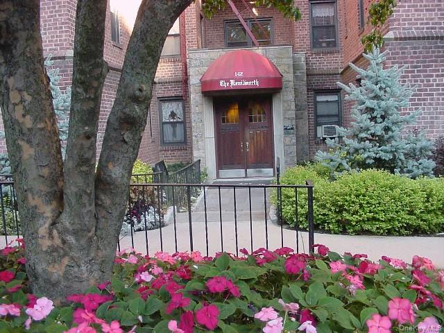 142 Garth Road, Unit 5S Scarsdale, NY 10583 - Photo 29 of 40 a view of a house with a flower garden