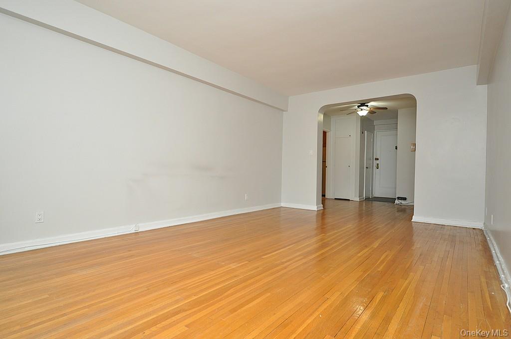 142 Garth Road, Unit 5S Scarsdale, NY 10583 - Photo 6 of 40 a view of an empty room with wooden floor