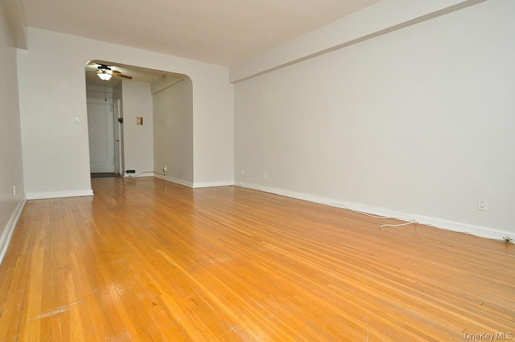 142 Garth Road, Unit 5S Scarsdale, NY 10583 - Photo 7 of 40 a view of an empty room with wooden floor