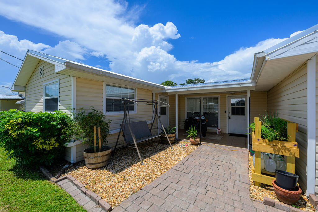 1044 4th Street Okeechobee, FL 34974 - Photo 1 of 39 a view of a house with chair in front of house