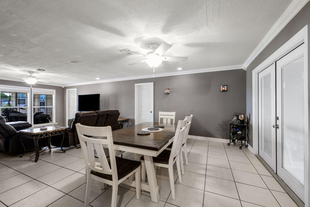 1044 4th Street Okeechobee, FL 34974 - Photo 14 of 39 a view of a dining room with furniture window and wooden floor