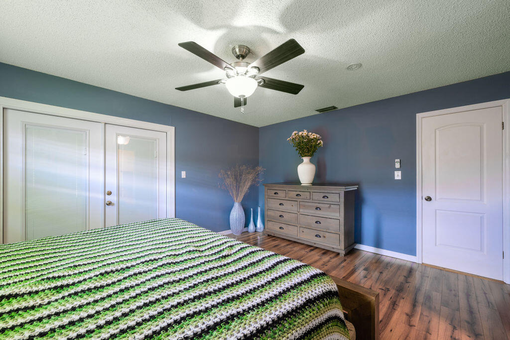 1044 4th Street Okeechobee, FL 34974 - Photo 16 of 39 a bedroom with a bed and a dresser