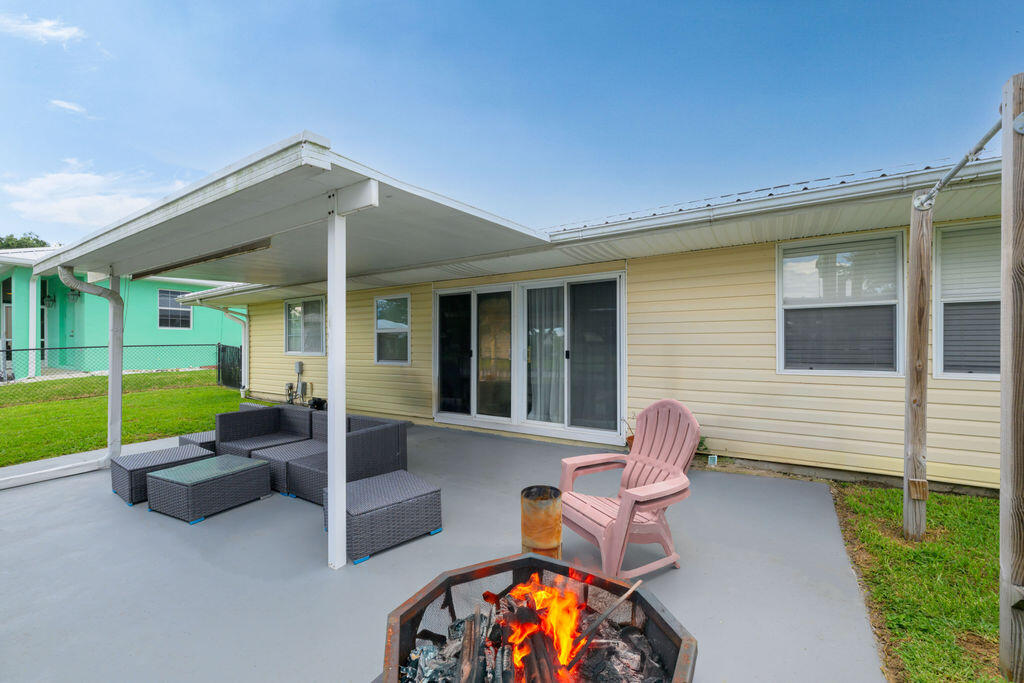 1044 4th Street Okeechobee, FL 34974 - Photo 32 of 39 a view of a house with backyard and porch